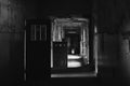 Greyscale shot of a creepy abandoned hallway inside of a building Royalty Free Stock Photo