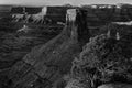 Greyscale shot of rock formations in the middle of the canyon