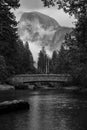 Greyscale shot of the Sentinal Bridge with the Half Dome batholith in the background, Yosemite