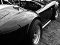 Greyscale shot of a vintage automobile Cobra 427 Shelby