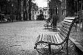 Greyscale shot of wooden benches near the trees captured in Saint Marks Square, Venice, Italy Royalty Free Stock Photo