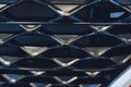 Grid of car with sunflare. Radiator grille. Metal close-up texture background. Chrome grill of big powerful engine macro Royalty Free Stock Photo