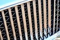 Grid of car with sunflare. Radiator grille. Metal close-up texture background. Chrome grill of big powerful engine macro