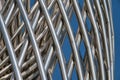 Grid of intertwined shiny metal poles. Modern architectural detail. Royalty Free Stock Photo