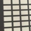 Grid-like pattern of shadows on a textured beige surface. The shadows create Royalty Free Stock Photo