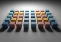 A grid of multicolored cubes is arranged on a flat, gray surface. Royalty Free Stock Photo