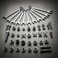Grid of nuts bolts and screws including wingnuts and hex nuts in different Royalty Free Stock Photo
