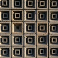 A grid-patterned wall features a design of recessed and protruded Royalty Free Stock Photo