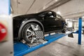 Grid sensor sets mechanic on auto. Car stand with sensors wheels for alignment camber check in workshop of Service