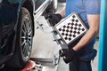 Grid sensor sets mechanic on auto. Car stand with sensors wheels for alignment camber check in workshop of Service