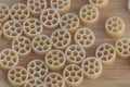 A grid of small pasta wheels, arranged on the table in an organized pattern Royalty Free Stock Photo