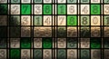 A grid of square tiles with numbers arranged in a grid pattern featuring digits from one to nine in shades of green and beige on Royalty Free Stock Photo