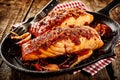 Griddle with Mexican style baked fish and fork Royalty Free Stock Photo