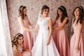 Gridesmaids help bride at her home. Morning of beaufiful bride. Girl`s hepl bride look wonderful Royalty Free Stock Photo