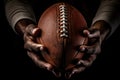 Gridiron Grip Close-Up: Detailed shot of an American football securely held in the hands of a focused football player