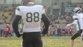 Gridiron players watching active fight for ball on field, American football game