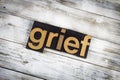 Grief Letterpress Word on Wooden Background
