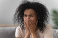 Grieving african woman crying sitting on couch Royalty Free Stock Photo