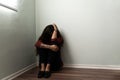 Grieving young woman sitting alone on the floor Royalty Free Stock Photo