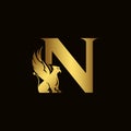 Griffin silhouette inside gold letter N. Heraldic symbol beast ancient mythology or fantasy. Creative design elements for logotype
