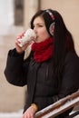 Gril drinking coffee in iwinter