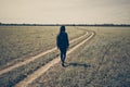 A gril walk sadly on wheel track Royalty Free Stock Photo