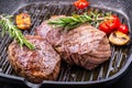 Grill beef steak. Portions thick beef juicy sirloin steaks on grill teflon pan or old wooden board Royalty Free Stock Photo