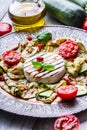 Grill Brie camembert cheese zucchini with chili pepper and olive oil. Italian mediterranean or greek cuisine. Royalty Free Stock Photo