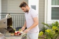 Grill chef cook. Guy with BBQ cooking tools. Barbecue and grill. Picnic and barbecue party. Chief cook with utensils for Royalty Free Stock Photo