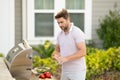 Grill chef cook. Guy with BBQ cooking tools. Barbecue and grill. Picnic and barbecue party. Chief cook with utensils for Royalty Free Stock Photo