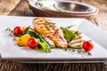 Grill chicken breast. Grilled vegetables with chicken breast. Grilled chicken with vegetables on oak table Royalty Free Stock Photo