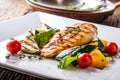 Grill chicken breast. Grilled vegetables with chicken breast. Grilled chicken with vegetables on oak table Royalty Free Stock Photo