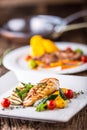 Grill chicken breast. Grilled vegetables with chicken breast. Grilled chicken with vegetables on oak table Royalty Free Stock Photo