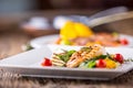 Grill chicken breast. Grilled vegetables with chicken breast. Grilled chicken with vegetables on oak table Royalty Free Stock Photo