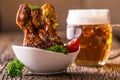 Grill chicken legs. Grilled chicken legs BBQ with sesame parsley tomato and draft beer Royalty Free Stock Photo