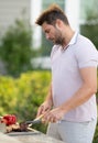 Grill cook. Chef with BBQ cooking tools. Barbecue and grill. Picnic and barbecue party. Chief cook with utensils for Royalty Free Stock Photo