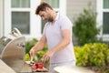 Grill cook. Chef with BBQ cooking tools. Barbecue and grill. Picnic and barbecue party. Chief cook with utensils for Royalty Free Stock Photo