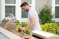 Grill cook. Chef with BBQ cooking tools. Barbecue and grill. Picnic and barbecue party. Chief cook with utensils for Royalty Free Stock Photo