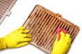 Grill after cooking. Steak marks on the electric home grill. Hand in yellow gloves clean grill grate from grease, fat, burnings. Royalty Free Stock Photo