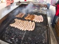 Grill frying fresh meat barbecue sausages, BBQ picnic sandwich store Royalty Free Stock Photo