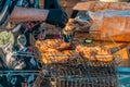 Grill with grilled meat in the hands of a chef