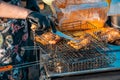 Grill with grilled meat in the hands of a chef