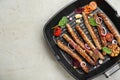 Grill pan with tasty sausages and vegetables on light table, top view. Space for text Royalty Free Stock Photo