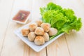 Grill pork balls with sweet spicy sauce on wooden table