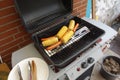 Grill with sausages and corn . Typical german grill station with tofu sausage and corncob . Barbecue cooking time . Grilling