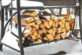 Grill in snowdrift. Chopped firewood from pine and birch for bbq under the snow on the street. Waiting for spring