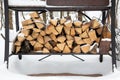 Grill in snowdrift. Chopped firewood from pine and birch for bbq under the snow on the street. Waiting for summer Royalty Free Stock Photo