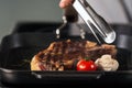 Grill steak at griddle pan. Closeup frying fork with grill beef.