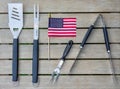 Grill tools on an outdoor table with an American flag