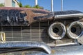 The grille and driver side headlamps on a black 1960 Plymouth Fury in Wells, Nevada, USA - June 18, 2022